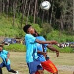 Korons player jumping up to head the ball against his YPS opponent in the Hotspring Alluvial Mining sponsored Xmas Sports Tournament played at Riverside Primary School Sports at field Ward 09 in Wau Rural LLG today.
