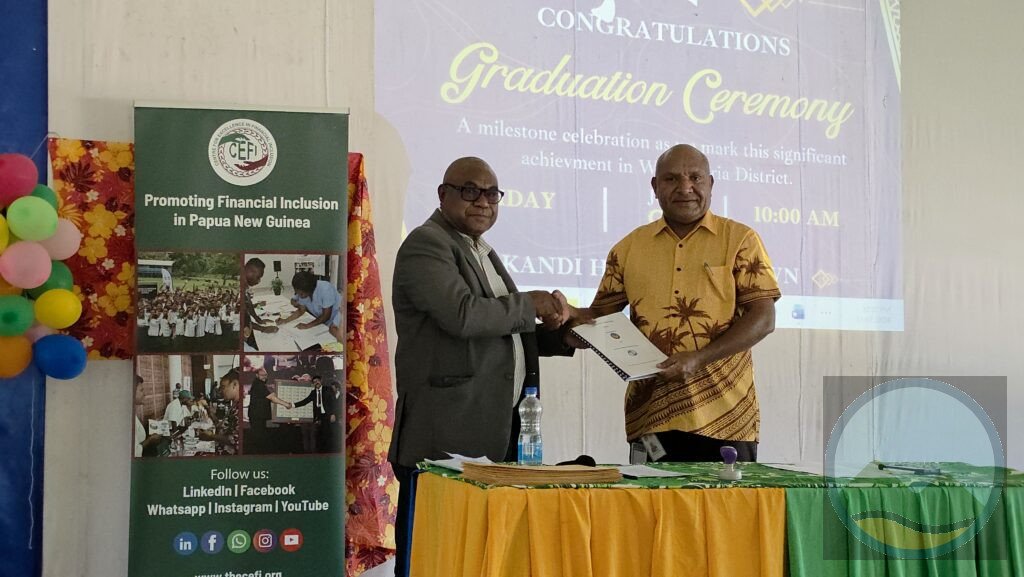 Wau Waria CEO John Orebut shaking hands with World Bank - CEFI's Master Trainer, Sebastian Mugup
